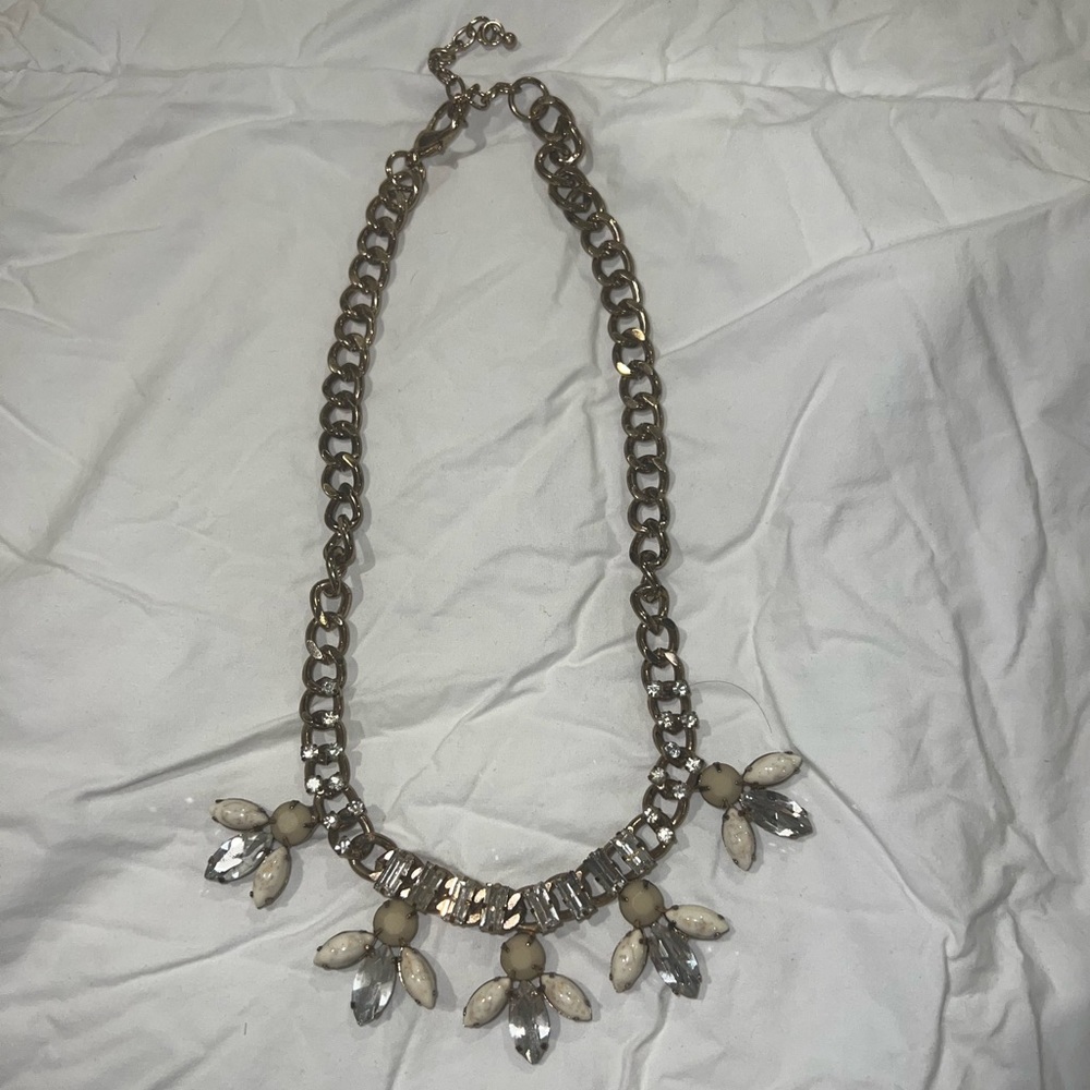 Necklace hangs within the neckline bought at Buckle